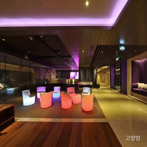 오렌지빛 LED 스툴이 놓인 넘버원 사우나의 감각적인 바 라운지, 마카오